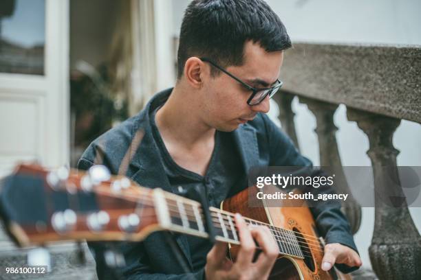 young guitarist with differing abilities - soloist stock pictures, royalty-free photos & images