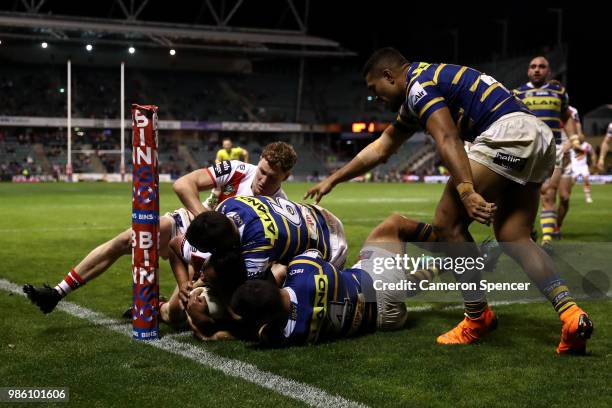 Luciano Leilua of the Dragons is held up over the tryline during the round 16 NRL match between the St George Illawarra Dragons and the Parramatta...