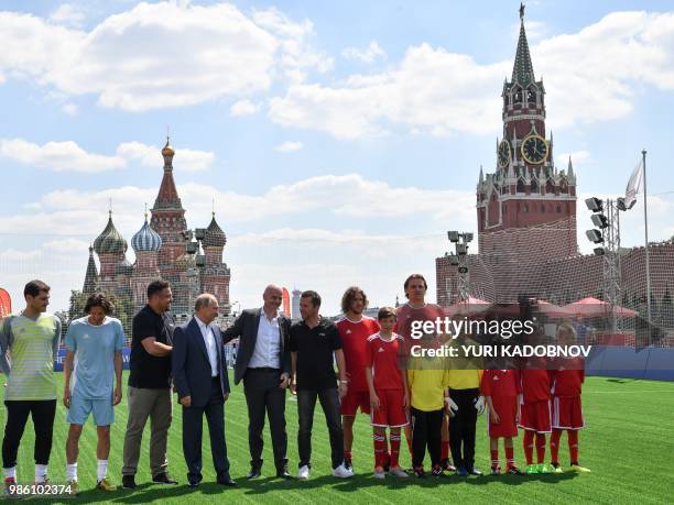 Russia's President Vladimir Putin and FIFA President Gianni Infantino pose for a picture with Russia's Football Union's anti-racism inspector Alexei...