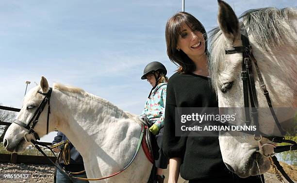 Samantha Cameron, wife of British opposition Conservative party leader David Cameron, pats a horse during an election campaign visit to The Avon...