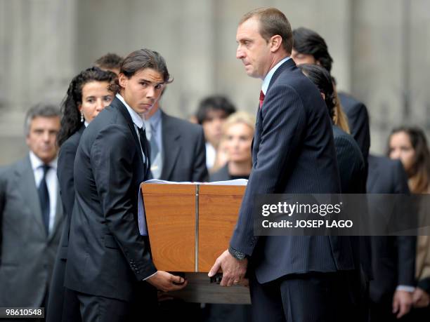 Spain's tennis player Rafael Nadal and Barcelona's handball player David Barrufet carry the coffin of former International Olympic Committee...