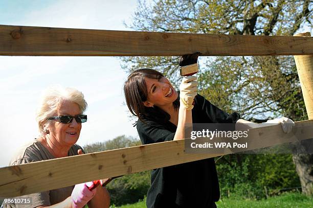 Samantha Cameron , wife of British opposition Conservative party leader David Cameron, helps to creosote a fence during an election campaign visit to...