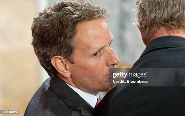 Timothy Geithner, U.S. Treasury secretary, left, talks to Tom Vilsack, U.S. Secretary of agriculture, during an event on strengthening global food...