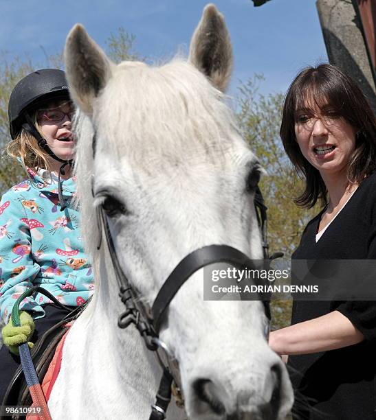 Samantha Cameron , wife of British opposition Conservative party leader David Cameron, pats a horse during an election campaign visit to The Avon...