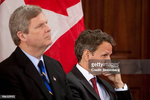 Timothy Geithner, U.S. Treasury secretary, right, and Tom Vilsack, U.S. Secretary of agriculture, listen during a meeting on strengthening global...