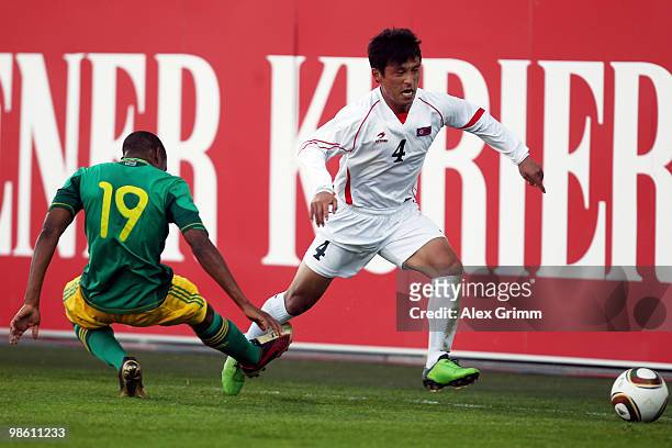 Pak Nam Chol of North Korea eludes Surprise Moriri of South Africa during the international friendly match between South Africa and North Korea at...