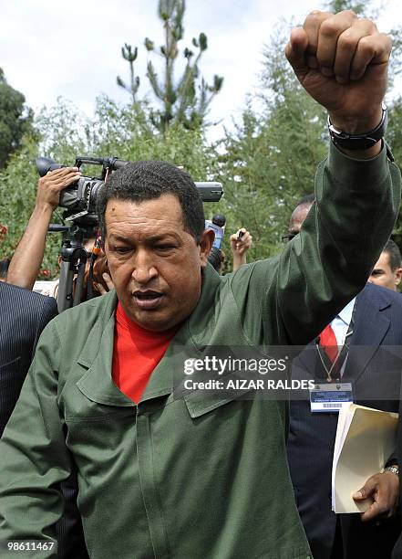 Venezuela's President Hugo Chavez clenches his fist as he leaves the closing ceremony of the Climate Summit in Tiquipaya 12 km from Cochabamba,...