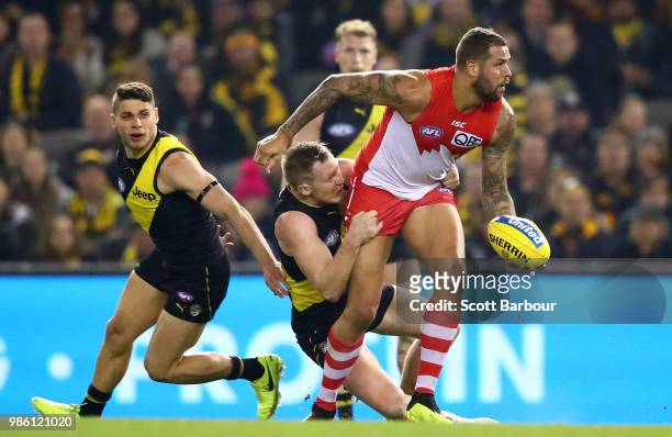 Lance Franklin of the Swans is tackled during the round 15 AFL match between the Richmond Tigers and the Sydney Swans at Etihad Stadium on June 28,...