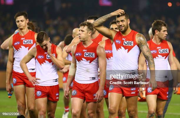 Lance Franklin of the Swans and his teammates leave the field after losing the round 15 AFL match between the Richmond Tigers and the Sydney Swans at...