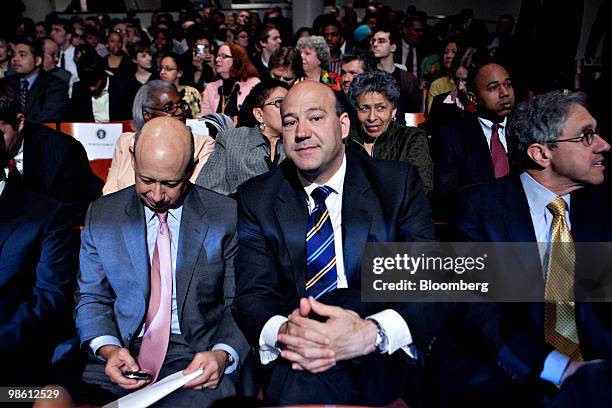 Lloyd C. Blankfein, chairman and chief executive officer of Goldman Sachs Group Inc., left, checks his Blackberry mobile phone as he sits with Gary...