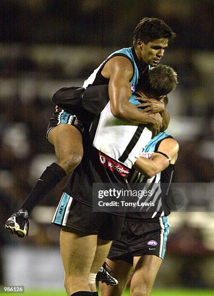 Che Cockatoo-Collins for Port Adelaide is congratulated by his captain Matthew Primus after he scored a goal in the final quarter to bring the margin...