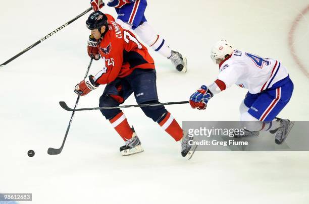 Jason Chimera of the Washington Capitals handles the puck against Maxim Lapierre of the Montreal Canadiens in Game One of the Eastern Conference...