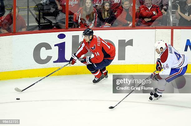 Tomas Fleischmann of the Washington Capitals handles the puck against Roman Hamrlik of the Montreal Canadiens in Game One of the Eastern Conference...