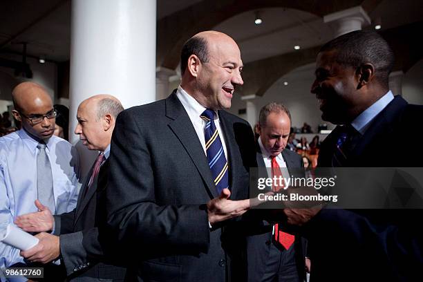 Gary D. Cohn, president and chief operating officer of Goldman Sachs Group Inc., center, speaks to another attendee as Lloyd C. Blankfein, chairman...