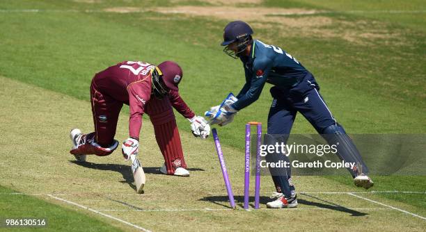 England Lions wicketkeeper Ben Foakes removes the bails to run out Raymon Reifer of West Indies A during the Tri-Series International match between...