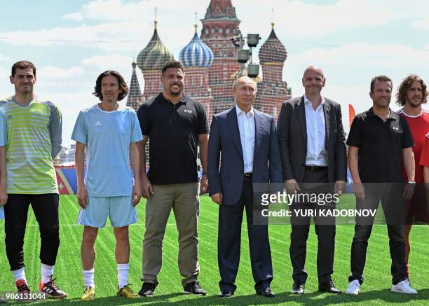 Russian President Vladimir Putin , FIFA President Gianni Infantino and Russian Football Union anti-racism and discrimination inspector Alexey Smertin...