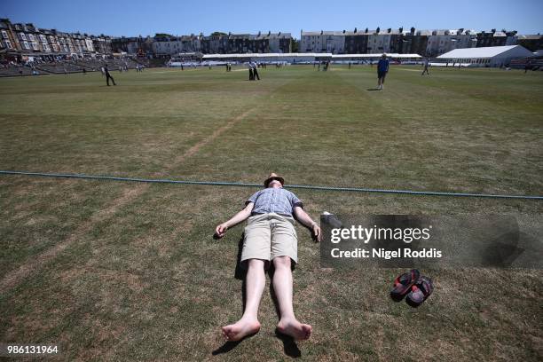 Man sunbathing during the intrval of the Specsavers County Championship Division One match between Yorkshire and Surrey on June 28, 2018 in...