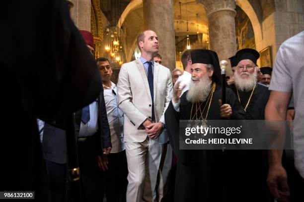 Britain's Prince William walks alongside Greek Orthodox Patriarch of Jerusalem Theophilos III as he visits the Church of the Holy Sepulchre in...