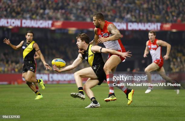 Reece Conca of the Tigers and Lance Franklin of the Swans compete for the ball during the 2018 AFL round15 match between the Richmond Tigers and the...