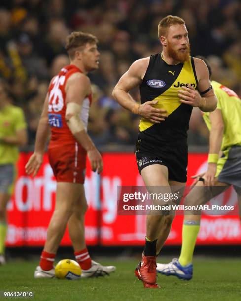 Luke Parker of the Swans and Nick Vlastuin of the Tigers look on during the 2018 AFL round15 match between the Richmond Tigers and the Sydney Swans...