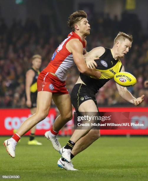 Jack Riewoldt of the Tigers and Dane Rampe of the Swans compete for the ball during the 2018 AFL round15 match between the Richmond Tigers and the...