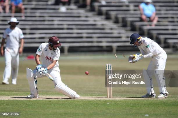 Scott Borthwick of Surrey is bowled out by Jack Leeming of Yorkshire during the Specsavers County Championship Division One match between Yorkshire...