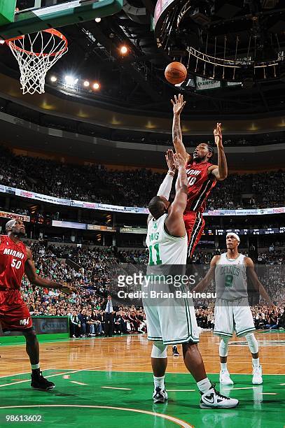 Udonis Haslem of the Miami Heat lays the ball up over Glen Davis of the Boston Celtics in Game Two of the Eastern Conference Quarterfinals during the...