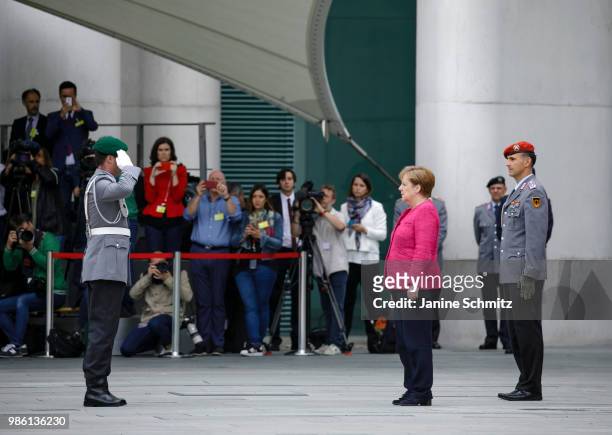 German Chancellor Angela Merkel waits for the Spanish Prime Minister Pedro Sanchez ahead of the welcome ceremony in the courtyard of the German...