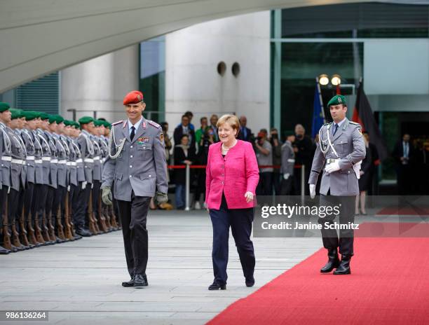 German Chancellor Angela Merkel waits for the Spanish Prime Minister Pedro Sanchez ahead of the welcome ceremony in the courtyard of the German...