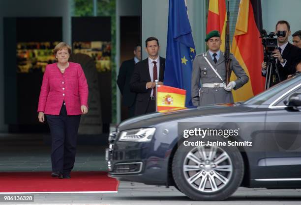 German Chancellor Angela Merkel waits for the Spanish Prime Minister Pedro Sanchez ahead of the welcome ceremony in the courtyard of the German...