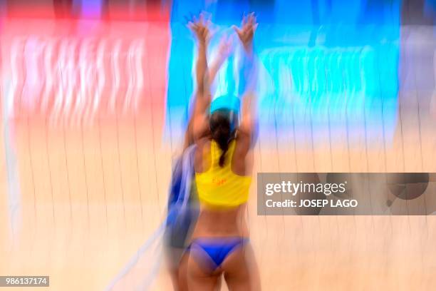 Spanish Amaranta Fernandez blocks a shot from Algerian Kawther Mehani during the Women's beach volley group G match 2 Spain vs Algeria at the XVIII...