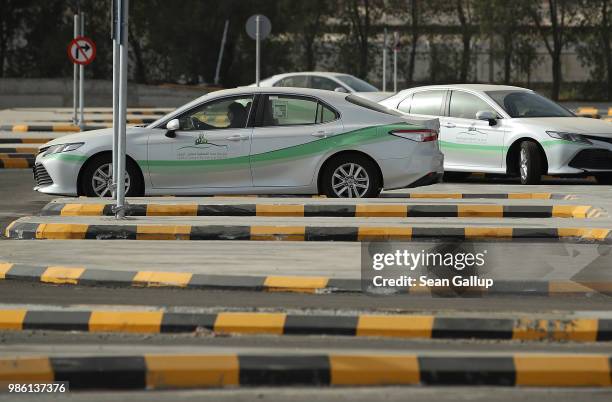 Women instructors and students practice driving at the Jeddah Advanced Driving School at King Abdulaziz University the day after women are once again...