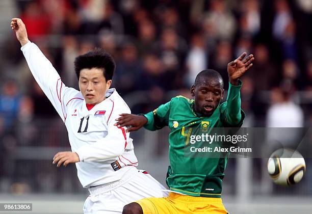 Mun In Guk of North Korea is challenged by Thanduyise Khuboni of South Africa during the international friendly match between South Africa and North...