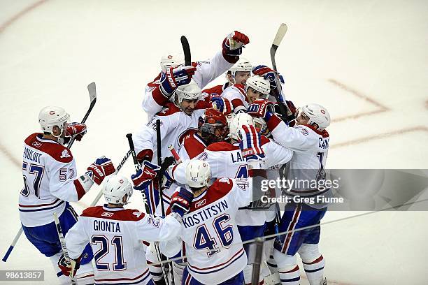 Tomas Plekanec of the Montreal Canadiens is mobbed by teammates after scoring the game winning goal in overtime against the Washington Capitals in...