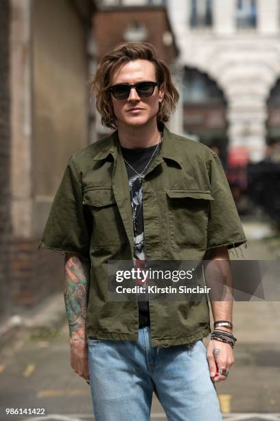 Musician from the band McFly and Model Dougie Poynter wears a Dries Van Noten shirt, Levi's jeans, Moscot sunglasses during London Fashion Week Men's...