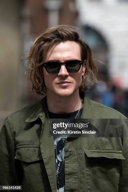 Musician from the band McFly and Model Dougie Poynter wears a Dries Van Noten shirt, Moscot sunglasses during London Fashion Week Men's on June 9,...