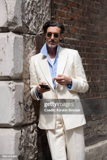 Model Richard Biedul wears a New and Lingwood suit during London Fashion Week Men's on June 9, 2018 in London, England.