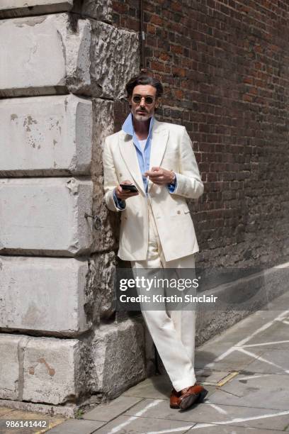 Model Richard Biedul wears a New and Lingwood suit during London Fashion Week Men's on June 9, 2018 in London, England.