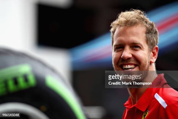 Sebastian Vettel of Germany and Ferrari looks on in the Paddock during previews ahead of the Formula One Grand Prix of Austria at Red Bull Ring on...