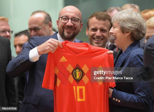 Charles Michel, Prime Minister of Belgium shows the jersey of Belgium football team to Theresa May, Prime Minister of United Kingdom during the EU...