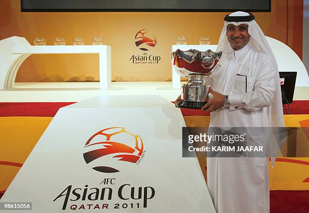 Saud al-Mohannadi, general secretary of the Qatar Football Association, holds the AFC trophy on the eve of the 2011 Asian Cup draw in the Qatari...
