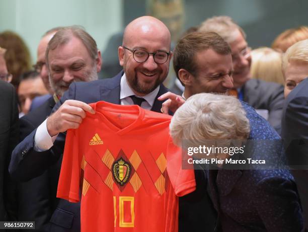 Charles Michel, Prime Minister of Belgium shows the jersey of Belgium football team to Theresa May, Prime Minister of United Kingdom during the EU...