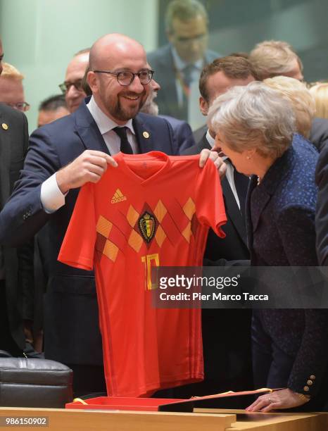 Charles Michel, Prime Minister of Belgium shows the jersey of Belgium football team to Theresa May, Prime Minister of United Kingdom during the EU...