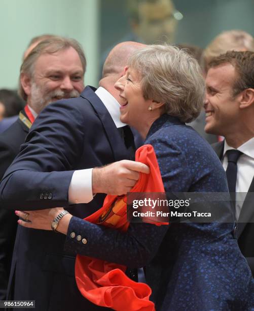 Charles Michel, Prime Minister of Belgium shows the jersey of Belgium football team to Theresa May, Prime Minister of United Kingdom during the EU...