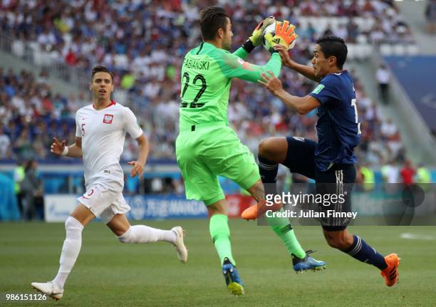 Lukasz Fabianski of Poland saves on Yoshinori Muto of Japan during the 2018 FIFA World Cup Russia group H match between Japan and Poland at Volgograd...