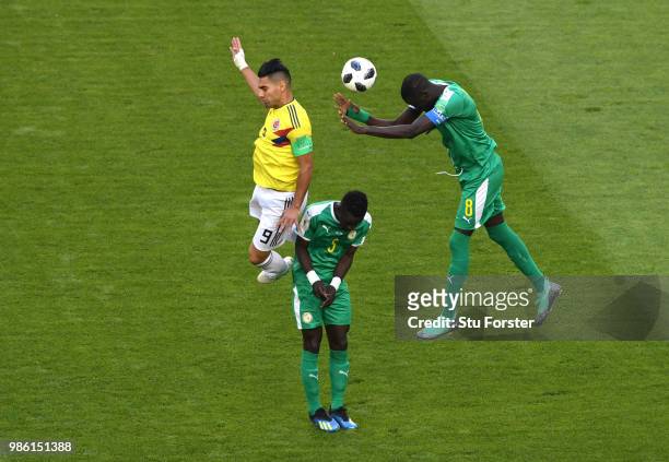 Cheikhou Kouyate of Senegal wins a header from Radamel Falcao of Colombia during the 2018 FIFA World Cup Russia group H match between Senegal and...