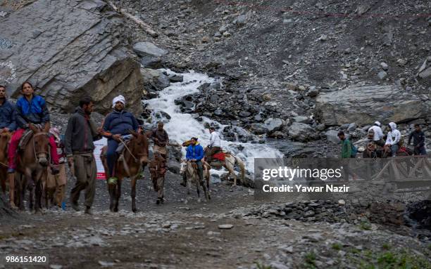 Hindu pilgrims on a mountain trail make their pilgrimage to the sacred Amarnath Caves during the annual Amarnath Hindu pilgrimage to the sacred...