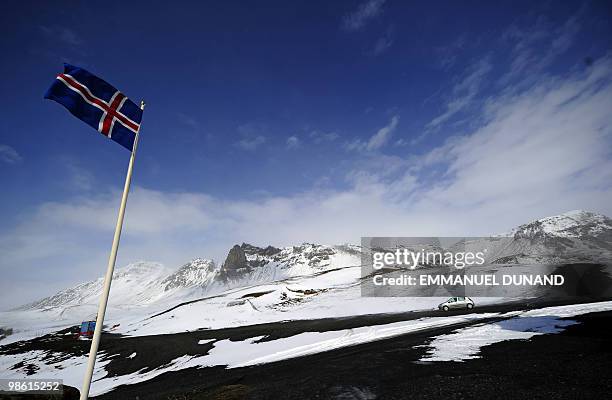 An Icelandic flag flies over Vik, a village sitting at the base of the Myrdalsjokull glacier, which is part of the ice cap sealing the Katla volcano,...