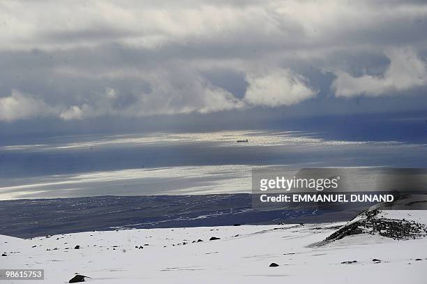 An Icelandic boats sails off Vik's coast, a village sitting at the base of the Myrdalsjokull glacier, which is part of the ice cap sealing the Katla...