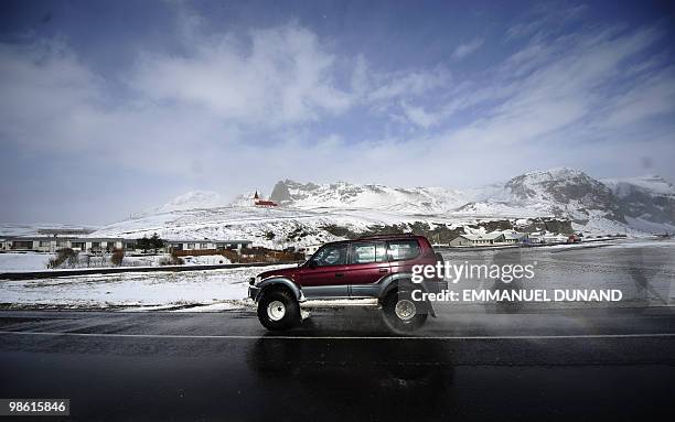 Car drives through Vik, a village set near the base of the Myrdalsjokull glacier, which is part of the ice cap sealing the Katla volcano, near Vik,...